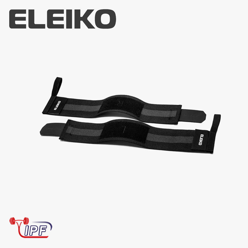 ELEIKO WL リストラップ IPF公認品 ブラックを真上から水平に広げた構図。左右のストラップ全体形状、手首サポート用パッド部分、親指ループ付き先端構造が分かるリストラップ