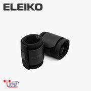 ELEIKO WL リストラップ IPF公認品 ブラックを斜め上から捉えた構図。巻いた状態のリストラップ2本とELEIKOロゴ入りラバーパッチ、厚手ナイロン素材の質感が分かるリストラップ