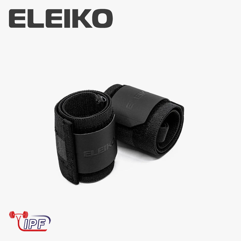 ELEIKO WL リストラップ IPF公認品 ブラックを斜め上から捉えた構図。巻いた状態のリストラップ2本とELEIKOロゴ入りラバーパッチ、厚手ナイロン素材の質感が分かるリストラップ