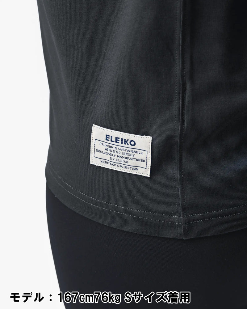 ELEIKO 1957 Tシャツ ユニセックス ブラック 裾タグ部分をクローズアップしブランドネームと縫製ディテールを確認できる構図